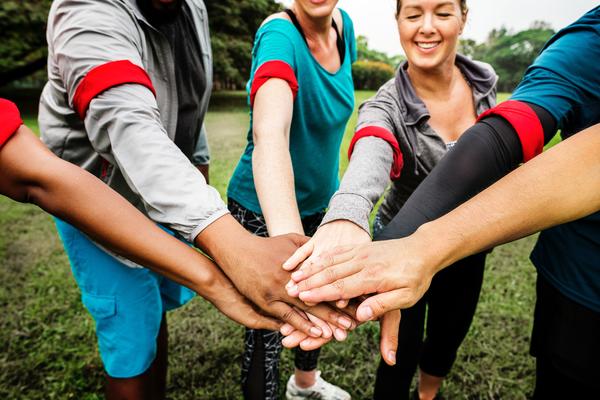 A group of people with hands in a circle